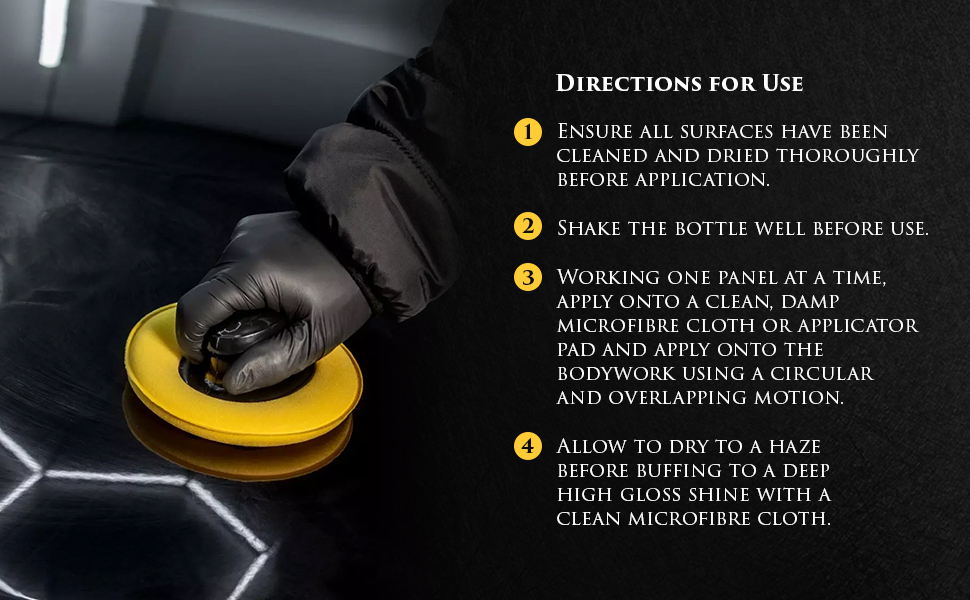 Image shows Diamond Black Wax being applied to a black vehicle with a yellow sponge applicator pad.