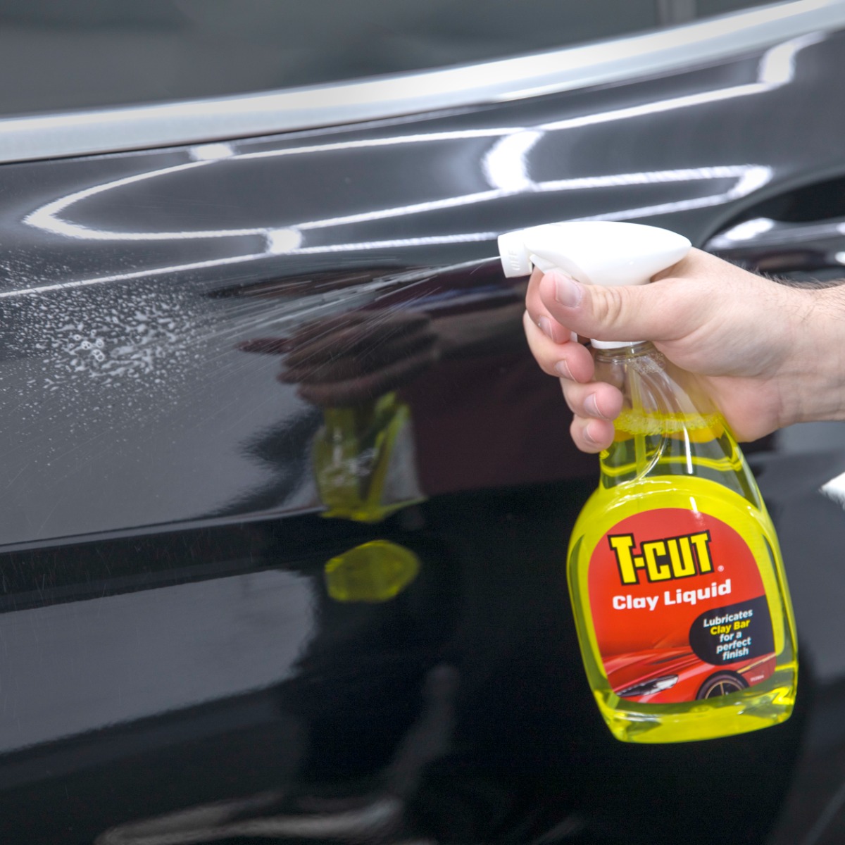 Spraying T-Cut Clay Liquid onto car